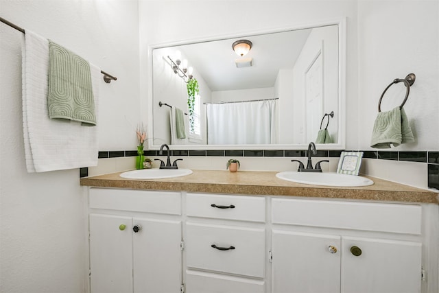 bathroom with walk in shower, vanity, and decorative backsplash