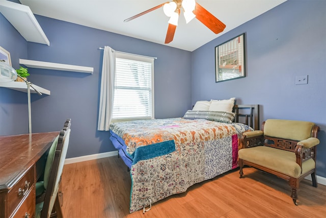 bedroom with ceiling fan and hardwood / wood-style floors