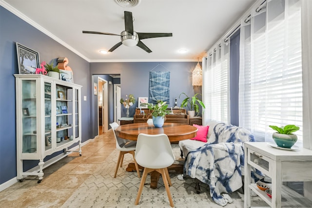 tiled dining area featuring visible vents, a ceiling fan, baseboards, and ornamental molding