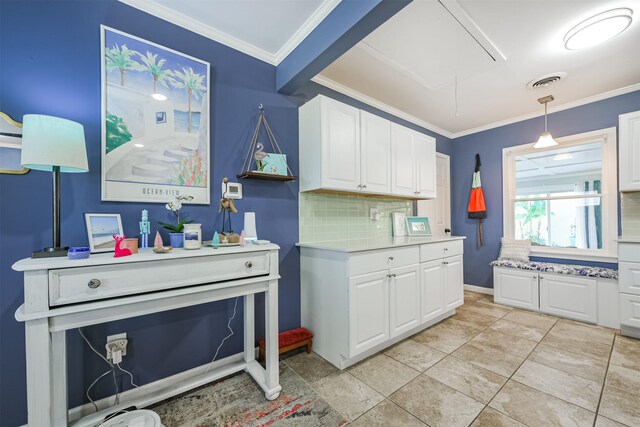 kitchen featuring visible vents, crown molding, white cabinetry, and light countertops