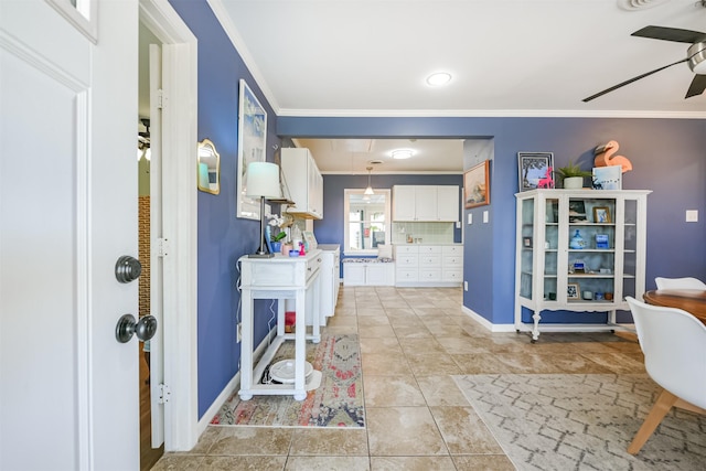 foyer featuring light tile patterned floors, baseboards, crown molding, and a ceiling fan