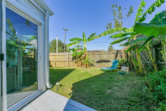 view of yard featuring a wooden deck and a fenced backyard