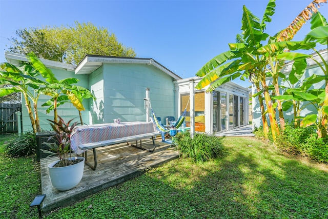 view of yard featuring a sunroom and a patio