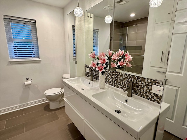 bathroom featuring vanity, an enclosed shower, and toilet