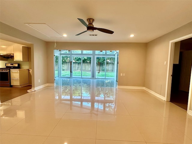 tiled empty room featuring ceiling fan