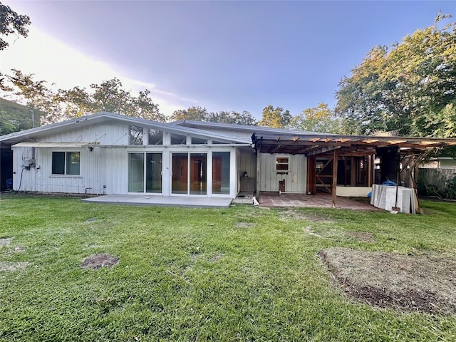 rear view of house with a pergola, a yard, and a patio