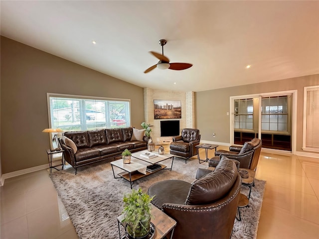 tiled living room featuring ceiling fan and lofted ceiling