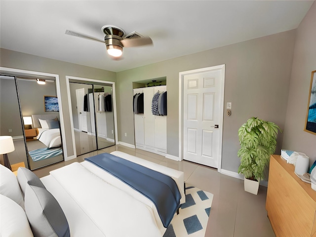 bedroom with ceiling fan, tile patterned flooring, and two closets