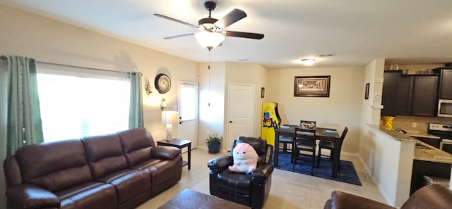 tiled living room featuring ceiling fan