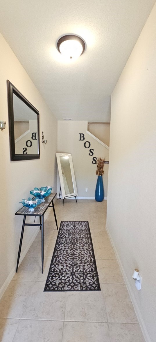 corridor with light tile patterned flooring