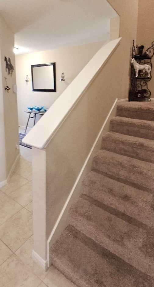 staircase featuring tile patterned floors