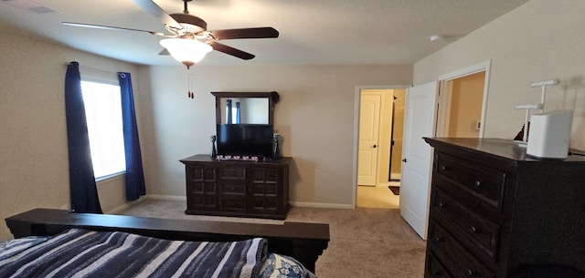 bedroom featuring light colored carpet, multiple windows, and ceiling fan