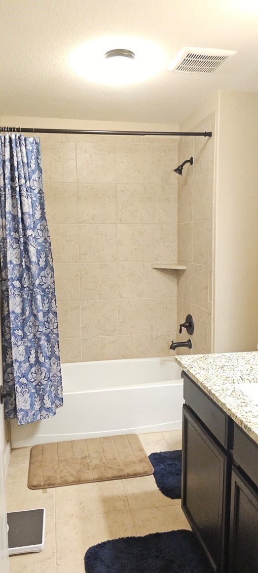 bathroom with tile patterned flooring, vanity, and shower / bath combo with shower curtain