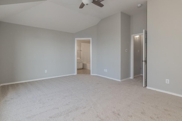 unfurnished bedroom with ensuite bathroom, vaulted ceiling, light carpet, and ceiling fan