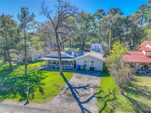 view of front of house with covered porch and a front yard