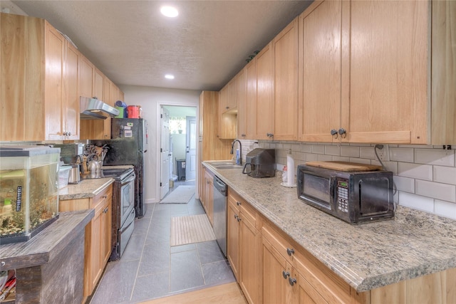 kitchen featuring light brown cabinets, black appliances, sink, tasteful backsplash, and light stone counters