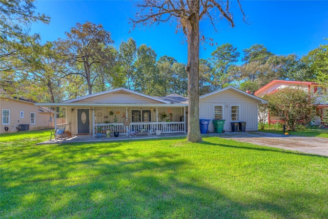 ranch-style house featuring a front yard, a porch, and central AC