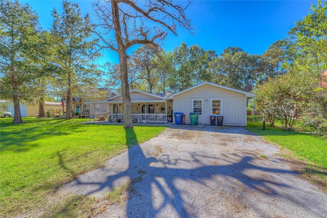 ranch-style home with covered porch and a front yard