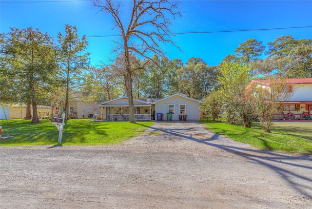 ranch-style house featuring a front lawn and a porch