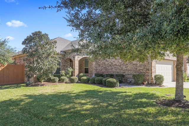 view of front of house with a garage and a front lawn