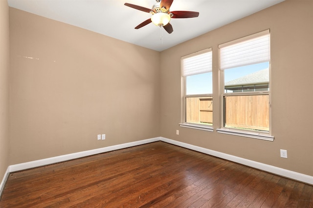 spare room featuring ceiling fan and dark wood-type flooring