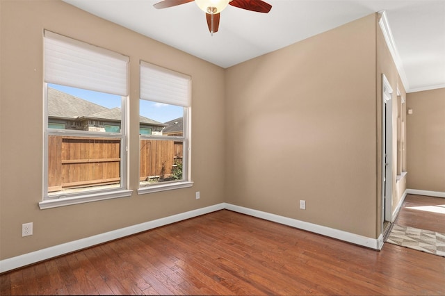 empty room with wood-type flooring, ceiling fan, and ornamental molding