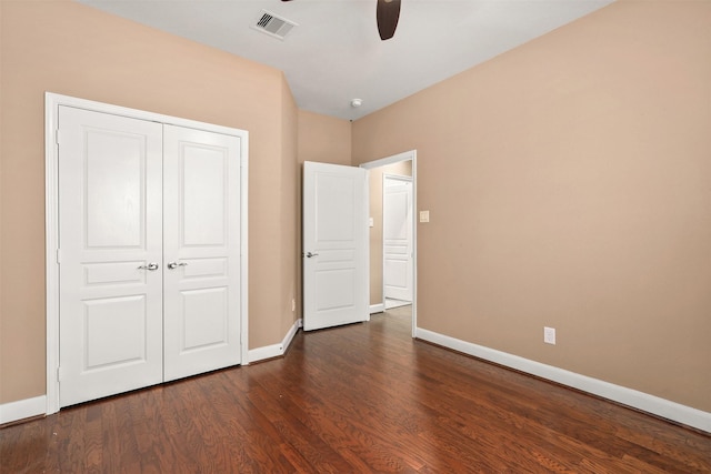 unfurnished bedroom featuring a closet, ceiling fan, and dark wood-type flooring