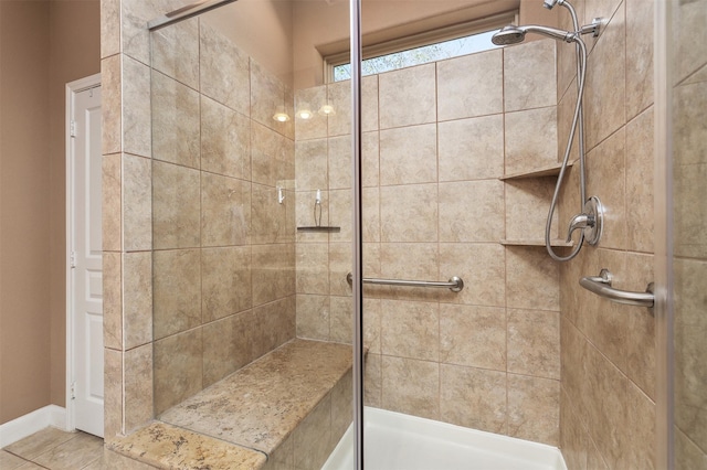 bathroom featuring a tile shower and tile patterned floors