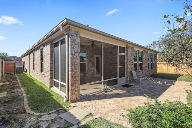 rear view of property featuring central AC unit and a patio area