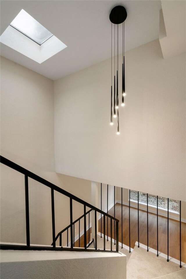 1300 Augusta Dr Unit 12, Houston, TX 77057 - staircase with carpet and a skylight