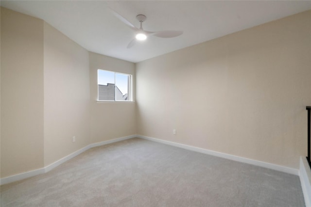 empty room with ceiling fan and light carpet