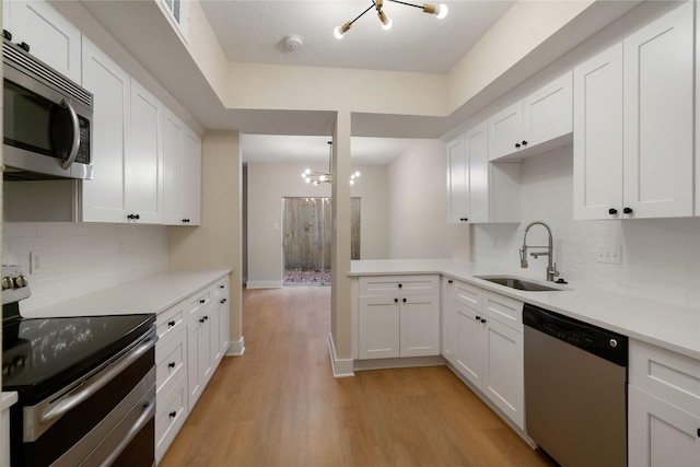 1300 Augusta Dr Unit 12, Houston, TX 77057 - kitchen featuring stainless steel appliances, tasteful backsplash, light countertops, and light wood finished floors