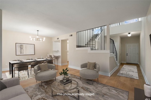 1300 Augusta Dr Unit 12, Houston, TX 77057 - living area with a chandelier, wood finished floors, and stairs