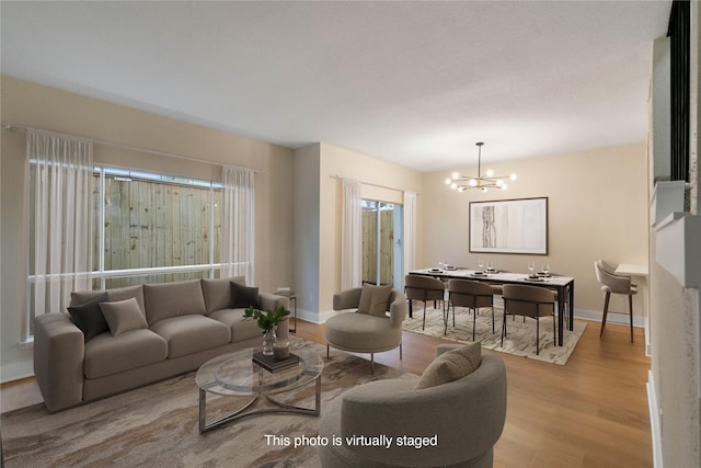 living room with a chandelier and light wood-type flooring