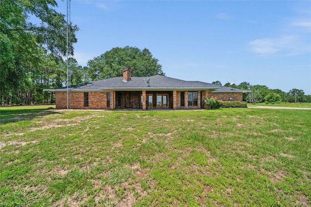 back of house featuring a yard