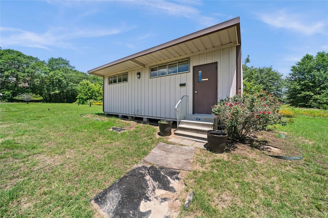 view of outbuilding featuring a yard