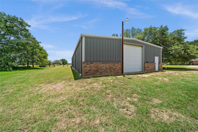 view of outbuilding with a lawn and a garage