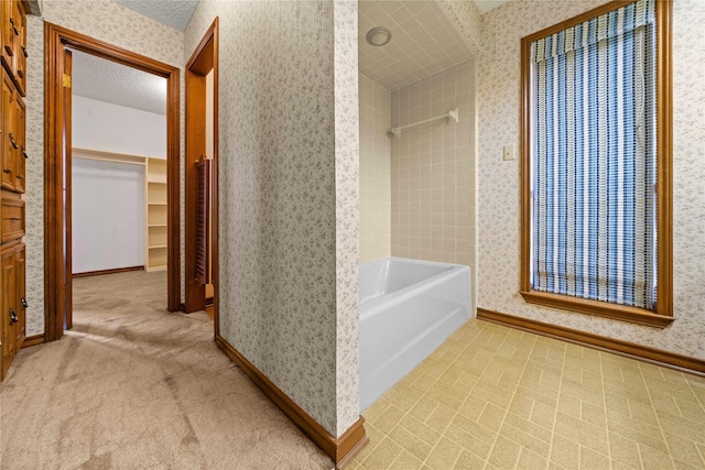 bathroom with shower with separate bathtub and a textured ceiling