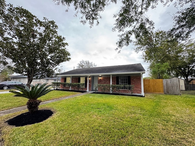 ranch-style house featuring a porch and a front lawn