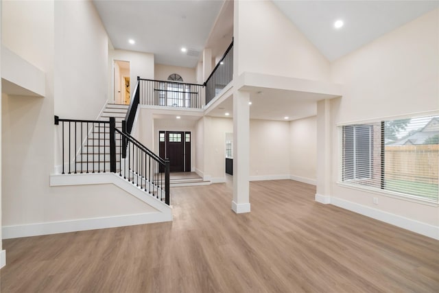 entrance foyer featuring light wood-type flooring and a high ceiling