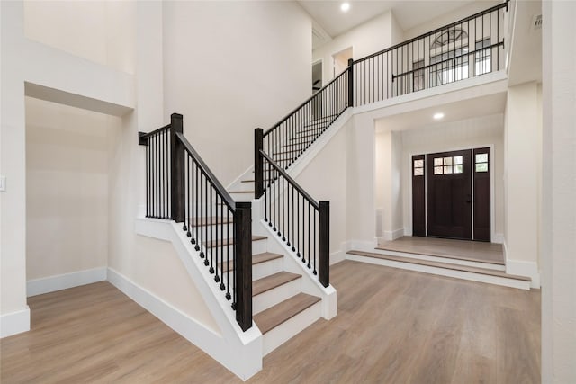 entrance foyer with light wood-type flooring and a high ceiling