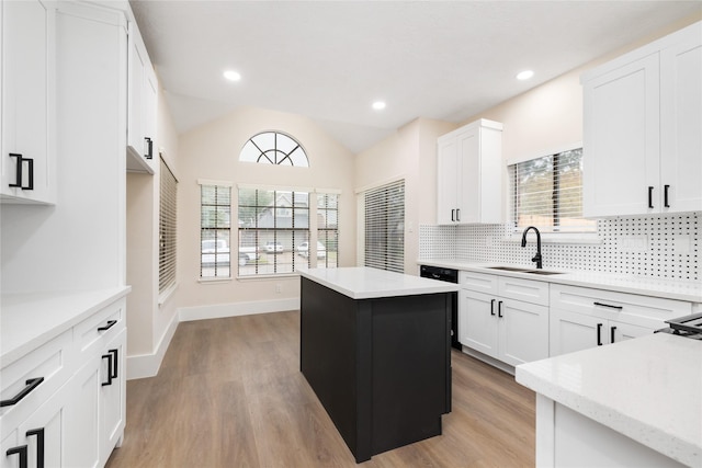 kitchen featuring white cabinetry, a kitchen island, plenty of natural light, and sink