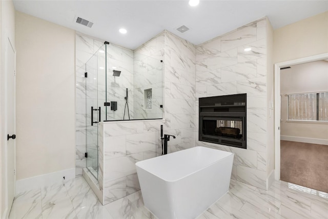 bathroom featuring a fireplace and independent shower and bath