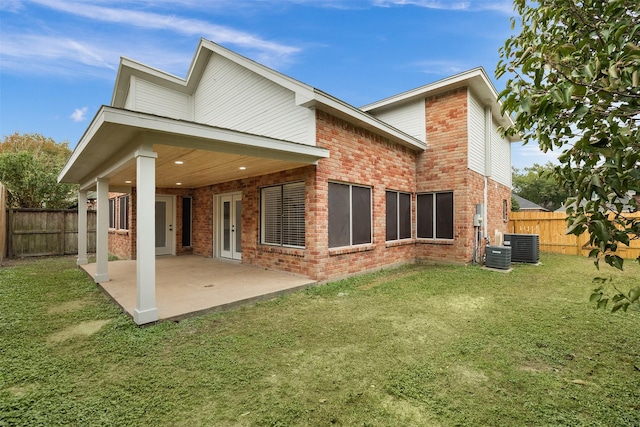 back of property featuring a patio area and a yard