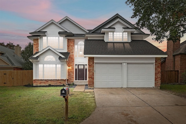 view of front of house featuring a yard and a garage