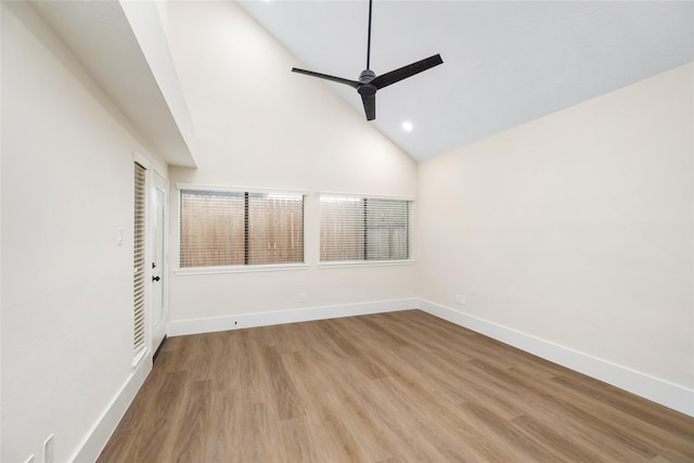 empty room with ceiling fan, light wood-type flooring, and high vaulted ceiling