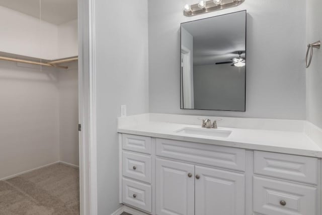 bathroom with ceiling fan and vanity