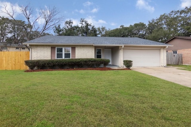 ranch-style house featuring a front yard and a garage