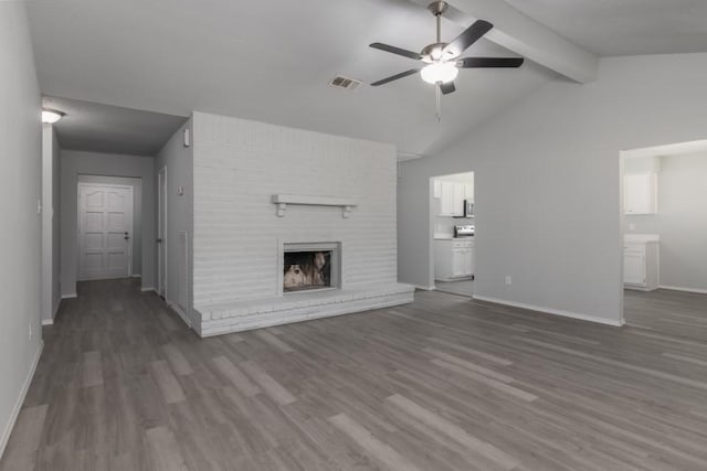 unfurnished living room featuring ceiling fan, vaulted ceiling with beams, dark hardwood / wood-style floors, and a fireplace