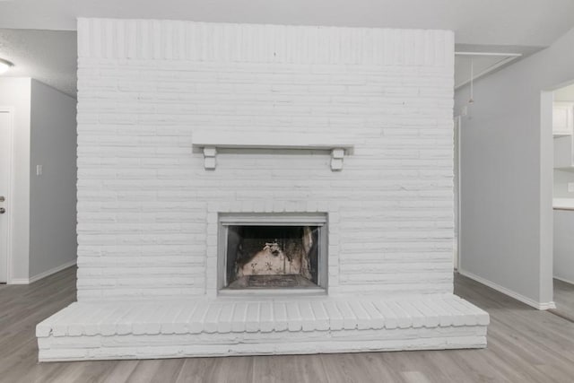 interior details featuring wood-type flooring and a fireplace